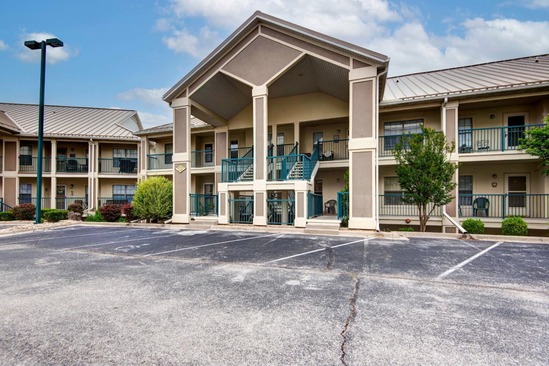 Exterior of Shoreline Haven condo building with parking in front