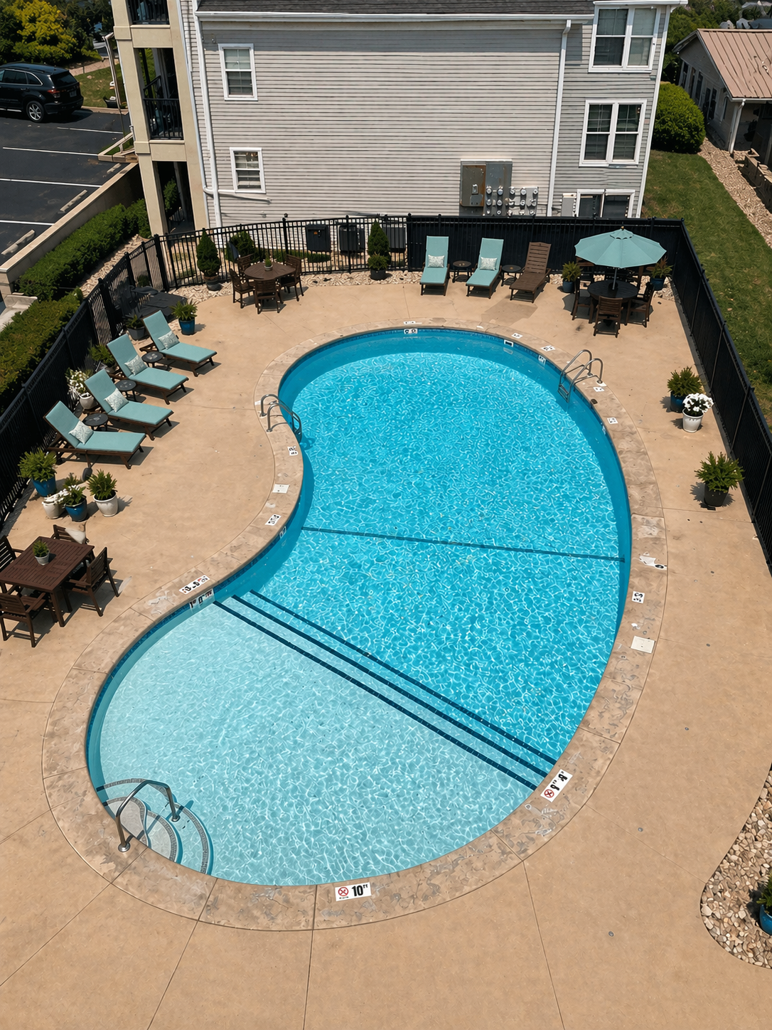 Community pool with lounge chairs and tables